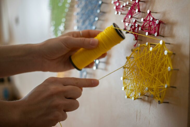 Person making string art